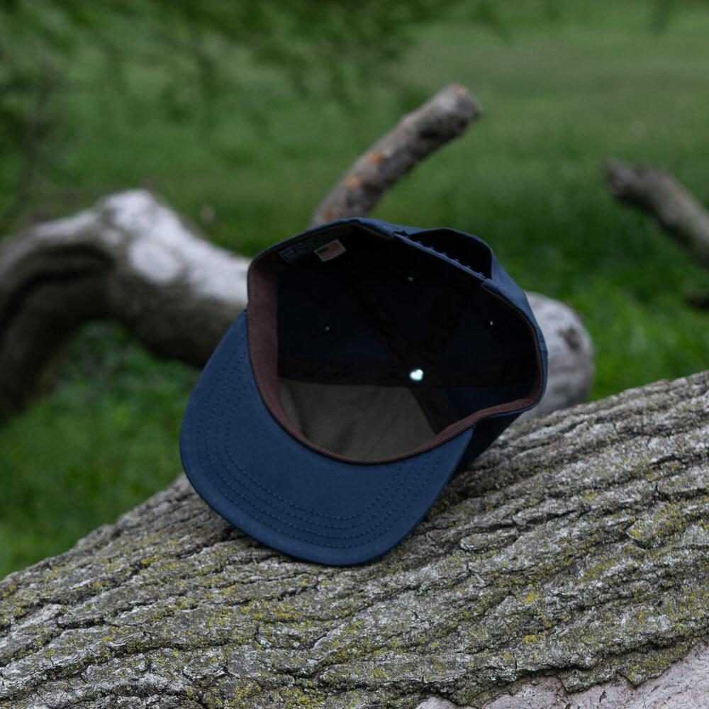 Navy Wax Snapback Hat By The Ampal Creative. Underside view.