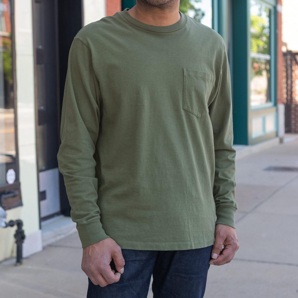 Seeker Long Sleeve Pocket Crewneck in olive. Close-up view.