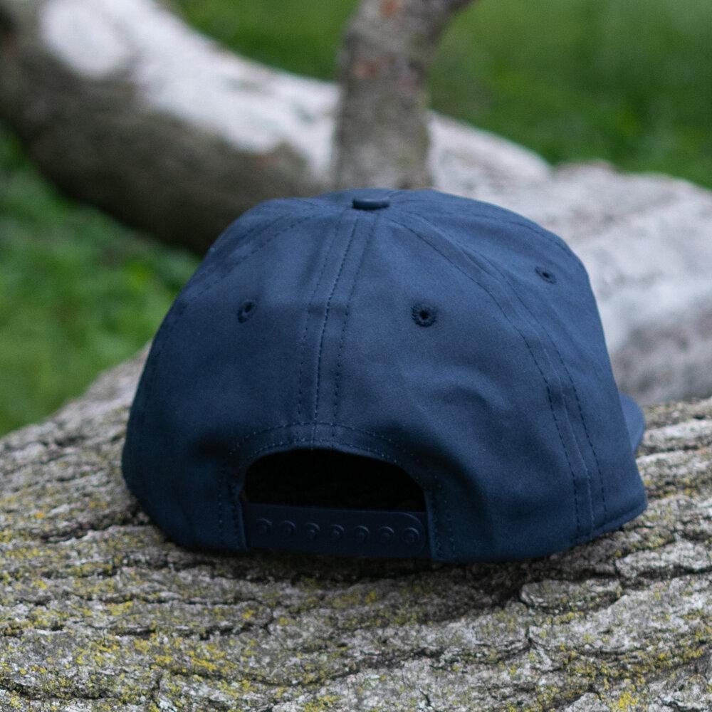 Navy Wax Snapback Hat By The Ampal Creative. Back view.