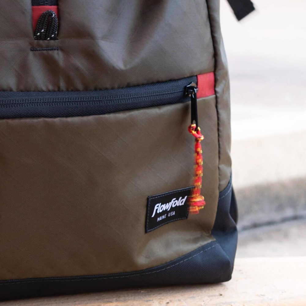 Commuter Center-zip Backpack in Olive by Flowfold. Lower zipper-pull view.