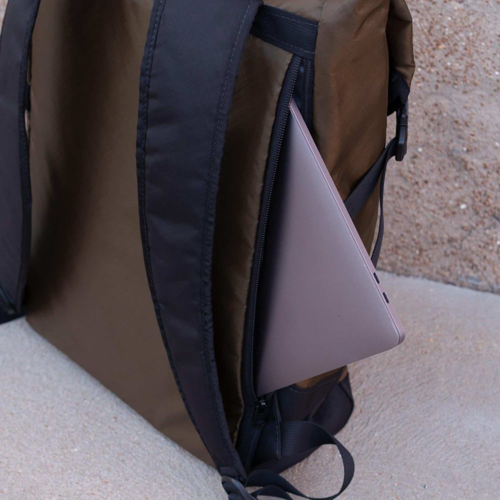 Commuter Center-zip Backpack in Olive by Flowfold. Side Laptop Compartment View.